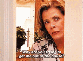 a woman is standing in a doorway and asking why are you trying to get me out of the house