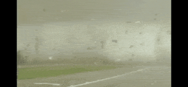 a view of a tornado from a car windshield with a white line on the road