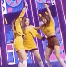 a group of young women are dancing on a stage .