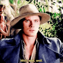 a man wearing a hat and a blue coat is saying well well well