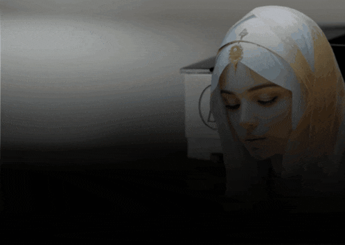 a woman wearing a veil with a gold pendant on her head