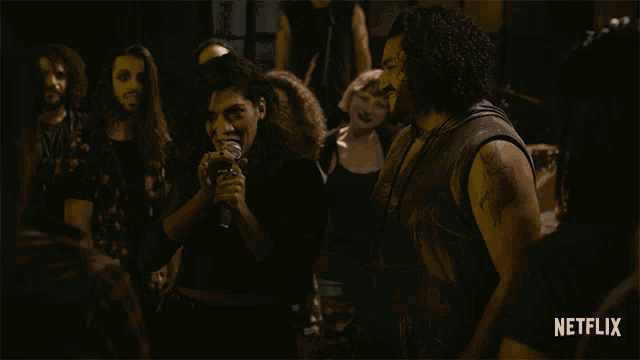 a group of people are dancing in front of a netflix ad