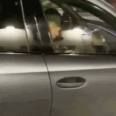 a close up of a car door with a person sitting in it