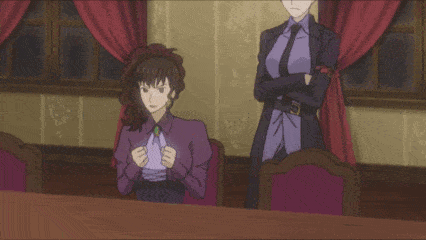 a woman in a purple shirt sits at a table