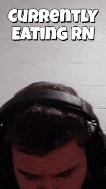 a man wearing headphones with the words currently eating rn above his head
