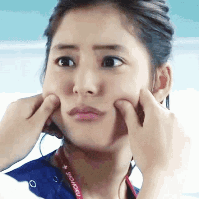 a woman with a lanyard around her neck that says showoku on it