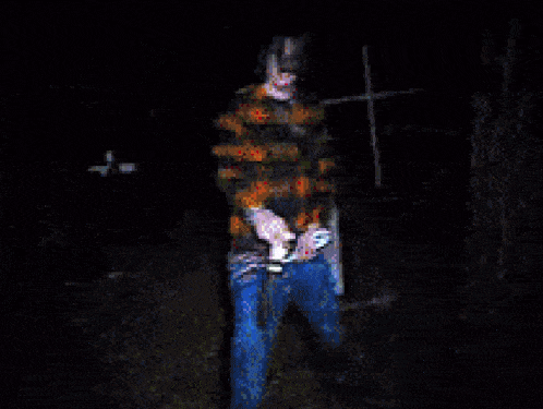 a pixelated image of a person wearing a plaid shirt and blue jeans