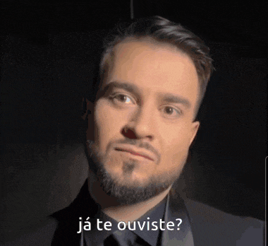 a man with a beard is wearing a black suit and has the words " ja te ouviste " on the bottom of his face