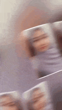 a blurry picture of a woman wearing a purple scarf and hijab