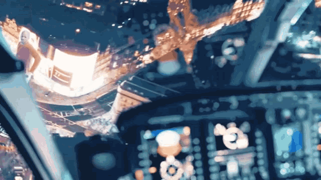 a blurred image of a helicopter cockpit with a reflection of a city
