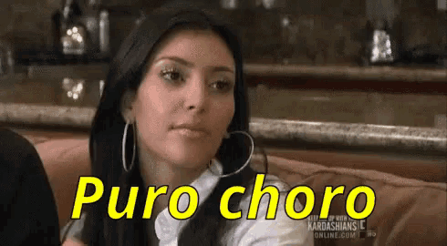 a woman wearing hoop earrings is sitting on a couch with the words puro choro written on her face