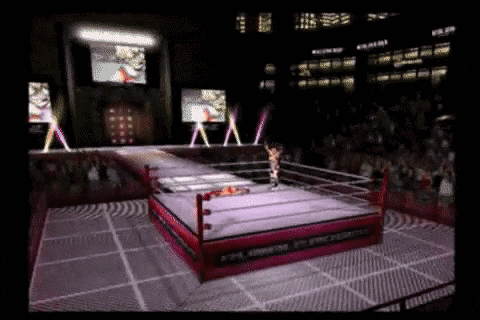 a video game shows a wrestling match in a ring with a crowd watching .
