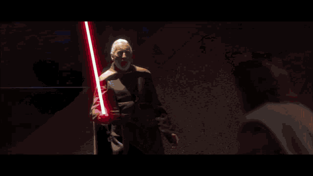 a person is holding a light saber in their hand in front of a red background