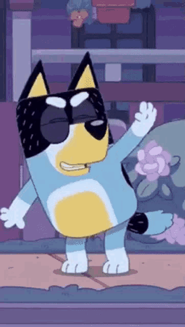 a cartoon dog wearing sunglasses is dancing on a stage in front of a flower .