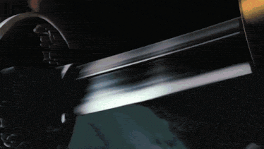 a close up of a sword with a purple glow