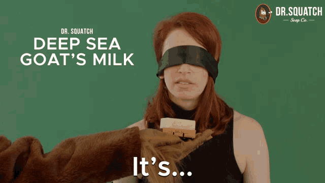 a poster for dr. squatch deep sea goat 's milk with a woman blindfolded