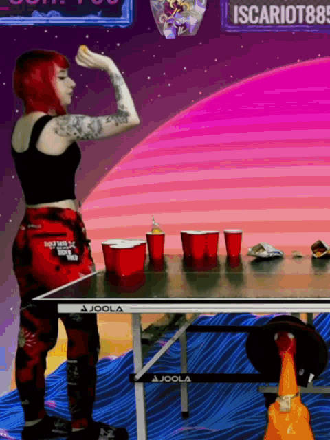 a woman with red hair is throwing a frisbee at a joola table