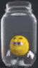a yellow smiley face is sitting in a clear jar .