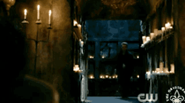 a room with candles and a cw logo