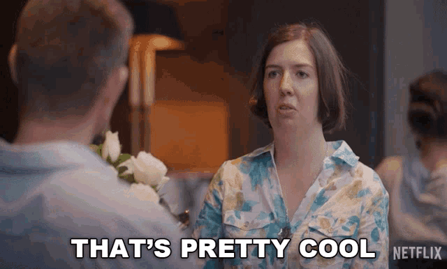 a woman is talking to a man and says that 's pretty cool netflix