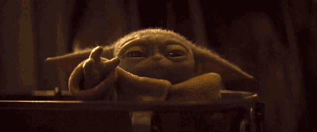 a close up of a baby yoda with a very angry look on his face