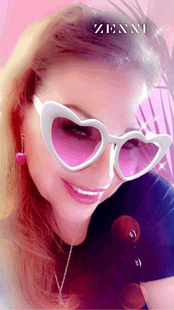 a woman wearing heart shaped sunglasses with the name zinni on the bottom right