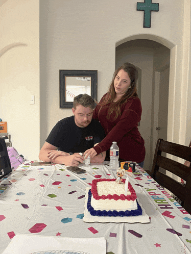 a woman helps a man cut a cake with a water bottle