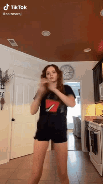 a girl is dancing in a kitchen with a tiktok watermark