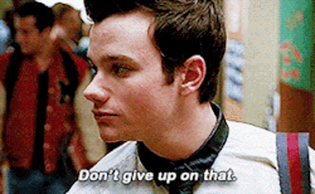 a man in a white shirt and tie is saying " don 't give up on that "