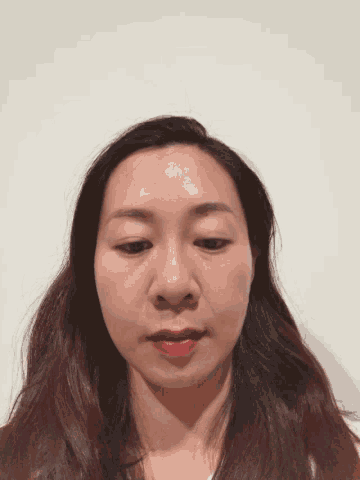 a close up of a woman 's face with a white background
