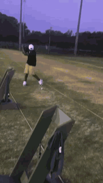 a man is swinging a golf club at a ball