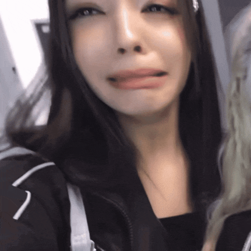 a close up of a woman making a funny face with her tongue hanging out