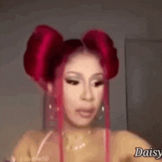 a woman with red hair is making a funny face while wearing two buns .