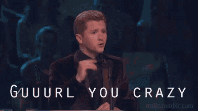 a man sitting at a table with the words " guuuurl you crazy " written on the bottom