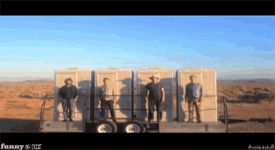 a group of men standing in front of a trailer that says funny and die
