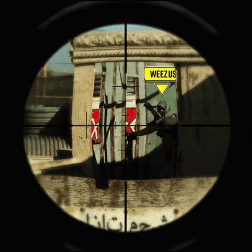 a sniper scope with a yellow sign that says weezus on it