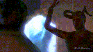 a man with horns on his head is standing in front of a blue light with nemo-beatrice written below him