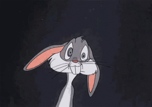 bugs bunny from the looney tunes cartoon is smiling and looking at the camera with his arms crossed .
