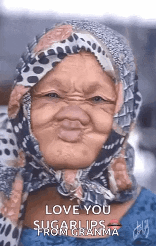 an elderly woman wearing a scarf around her head making a funny face .