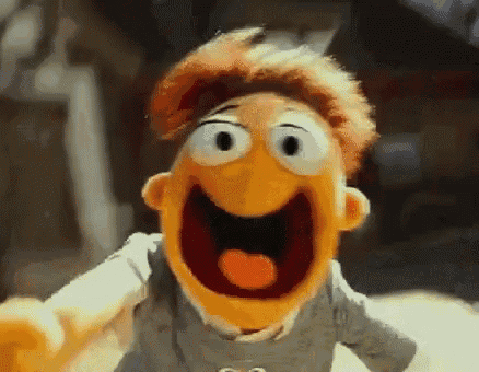 a close up of a puppet with his mouth open and his eyes closed .