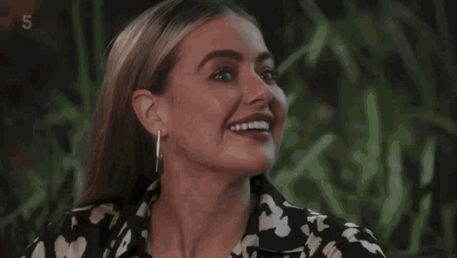 a close up of a woman 's face with the number 5 behind her