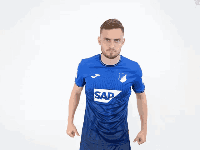 a man wearing a blue shirt with the word sap on the front