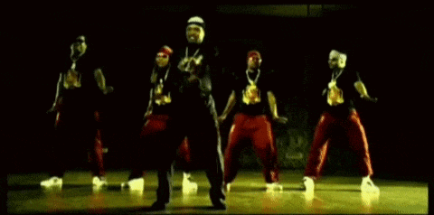 a group of men are dancing together on a stage