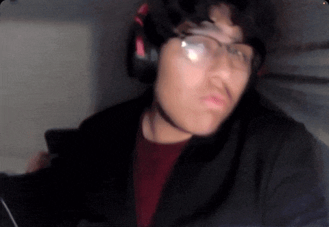 a man wearing glasses and headphones looks at the camera