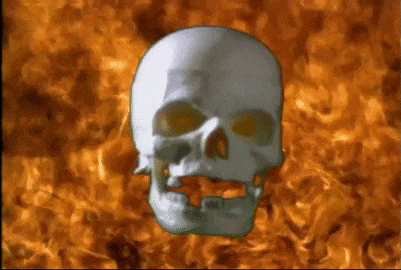 a skull with glowing eyes is against a background of fire