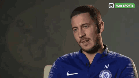 a man with a beard wearing a blue nike jacket with the number 10 on it