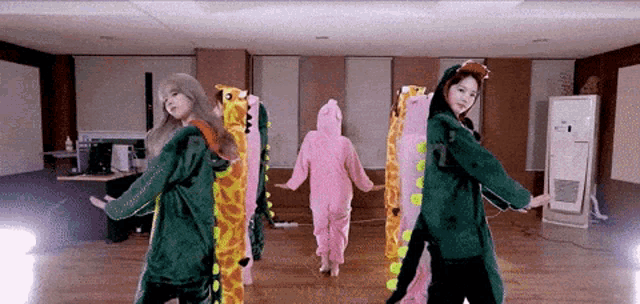 a group of girls are dancing in a room with stuffed animals on their heads .
