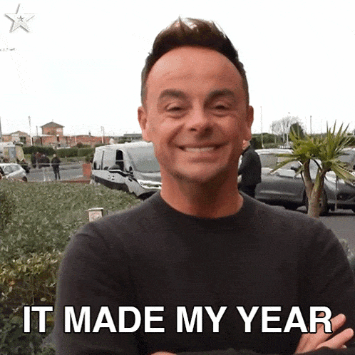 a man with his arms crossed is smiling with the words it made my year behind him