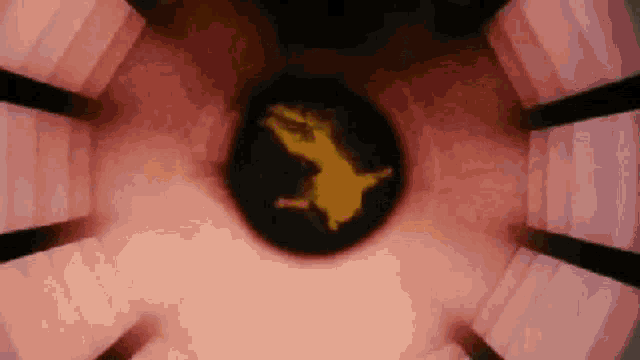 a person is flying through the air in a circle in a dark room .