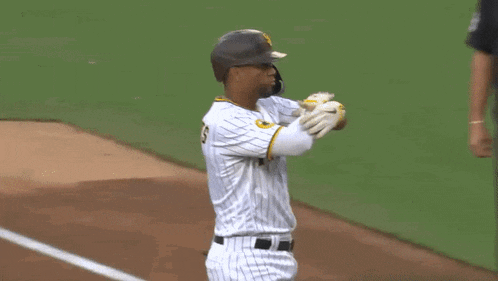 a baseball player with the number 1 on his jersey shakes hands with another player